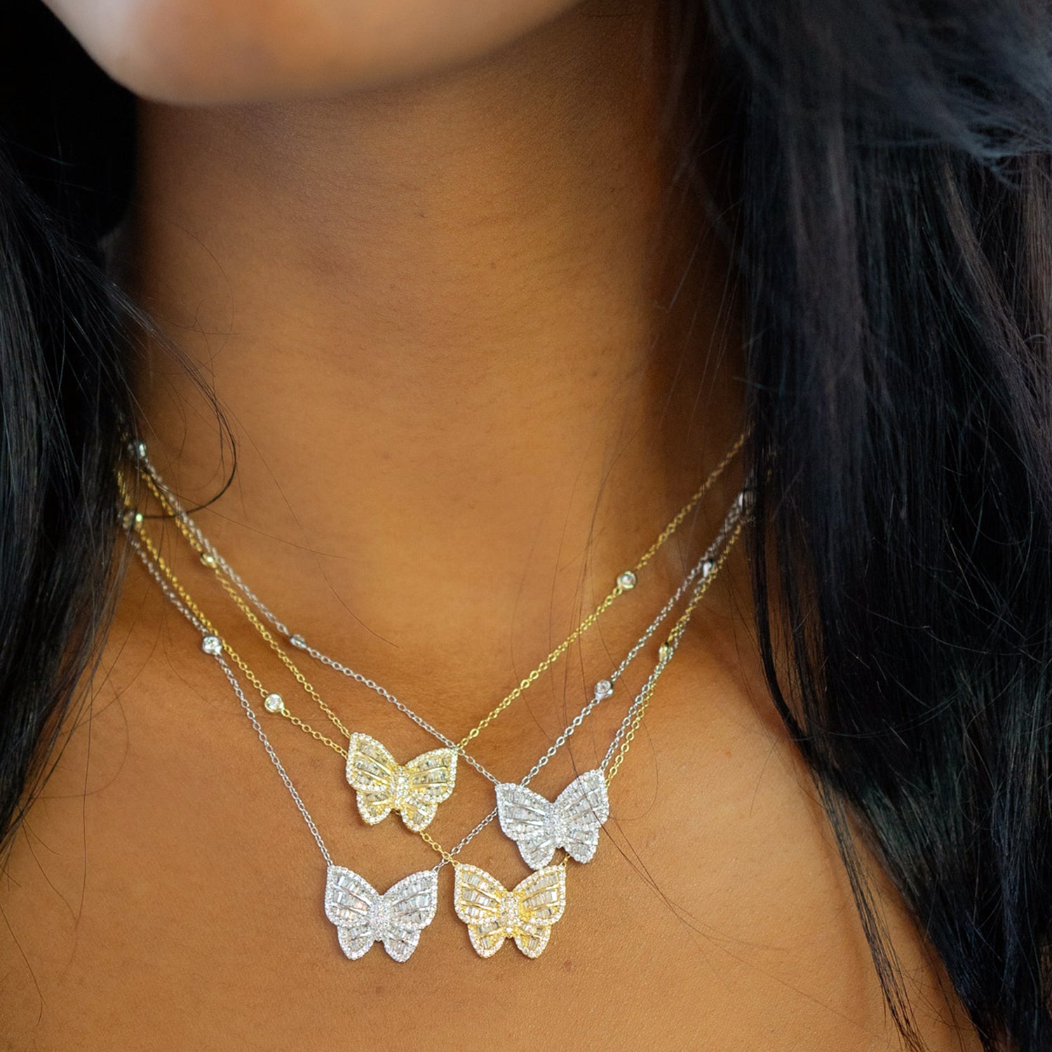 Wearing gold and silver butterfly CZ necklaces from Alexandra Marks Jewelry
