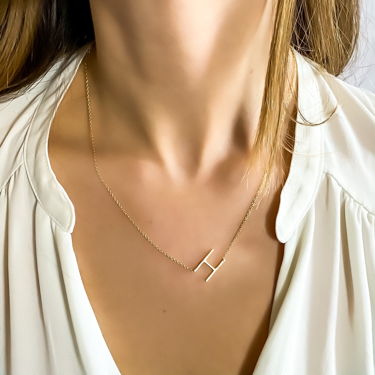 Wearing the gold letter H initial necklace from Alexandra Marks jewelry