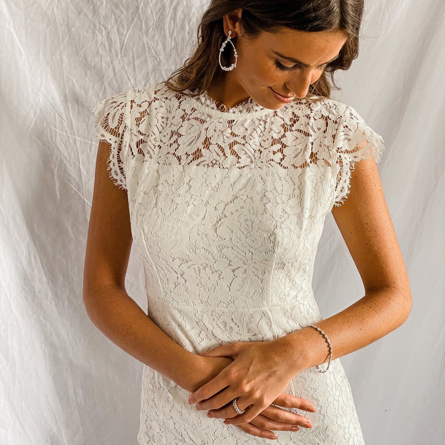 a bride wearing Alexandra Marks perfectly pear shaped CZ earrings