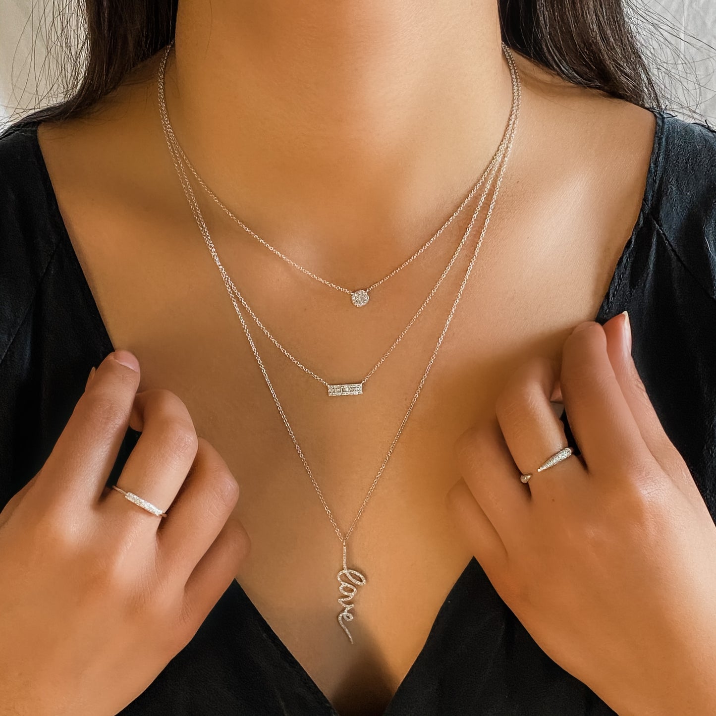 Wearing the petite diamond disc necklace layered with other white gold diamond necklaces from Alexandra marks Jewelry