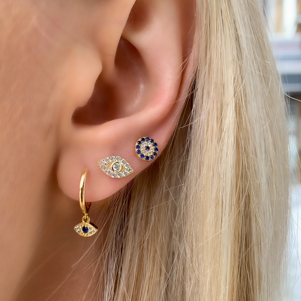 Alexandra Marks wearing the gold evil eye charm huggie hoop earrings