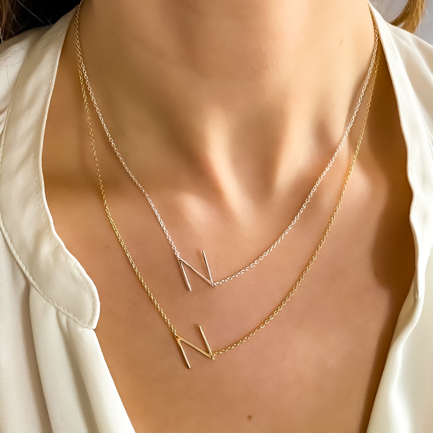 Wearing the silver and gold sideways letter N initial Necklace from alexandra marks jewelry