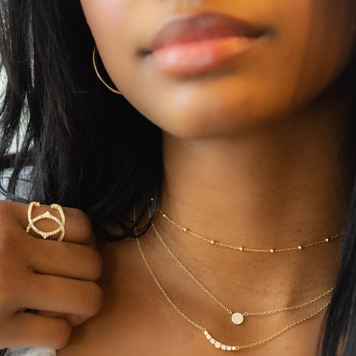 Wearing the gold bead choker stacked with two other gold necklaces from Alexandra Marks Jewelry
