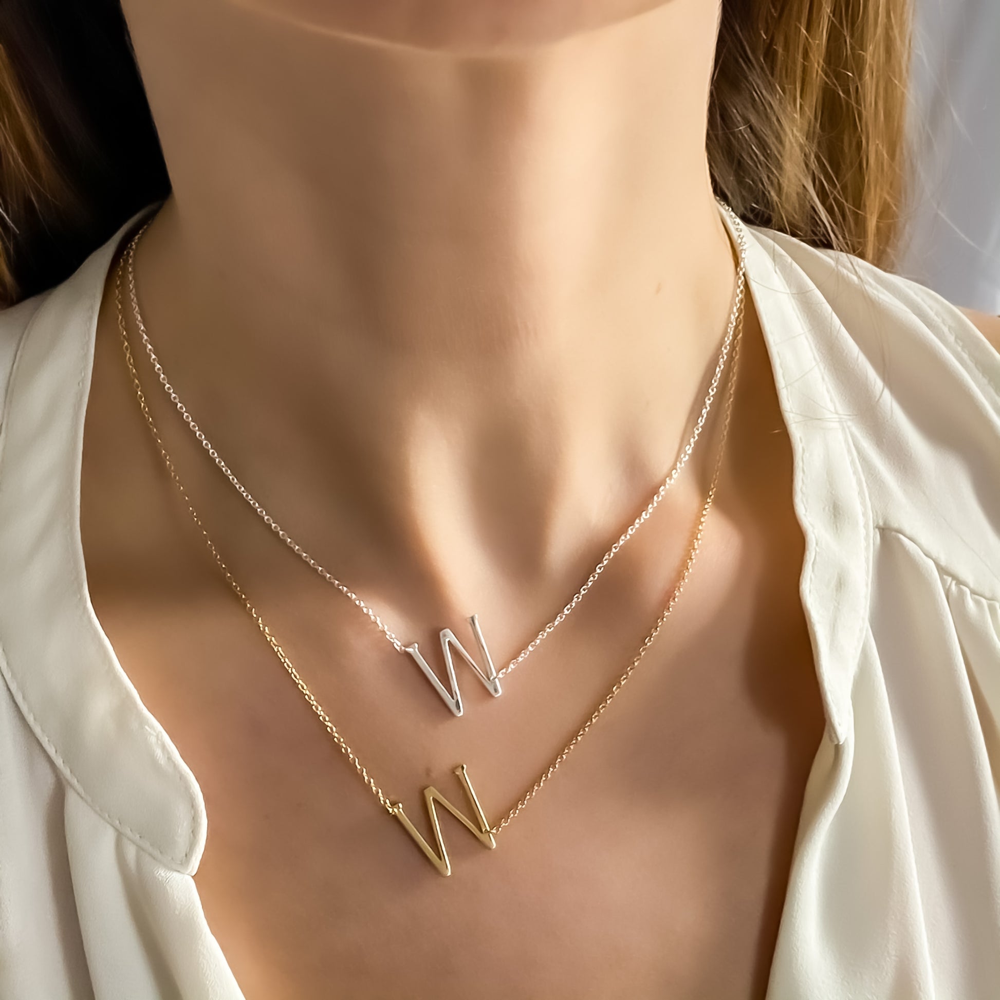 Wearing the silver and gold Letter W necklaces from Alexandra Marks Jewelry