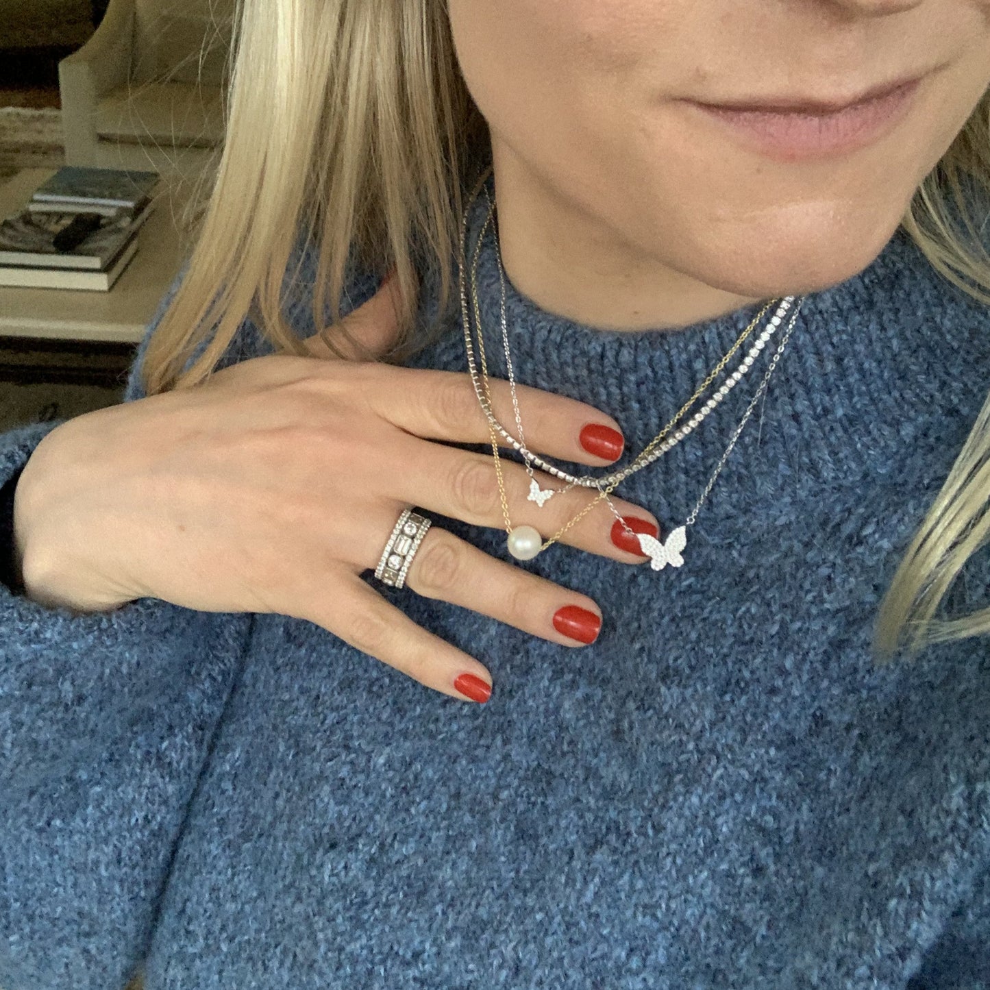 The silver double butterfly necklace on a woman