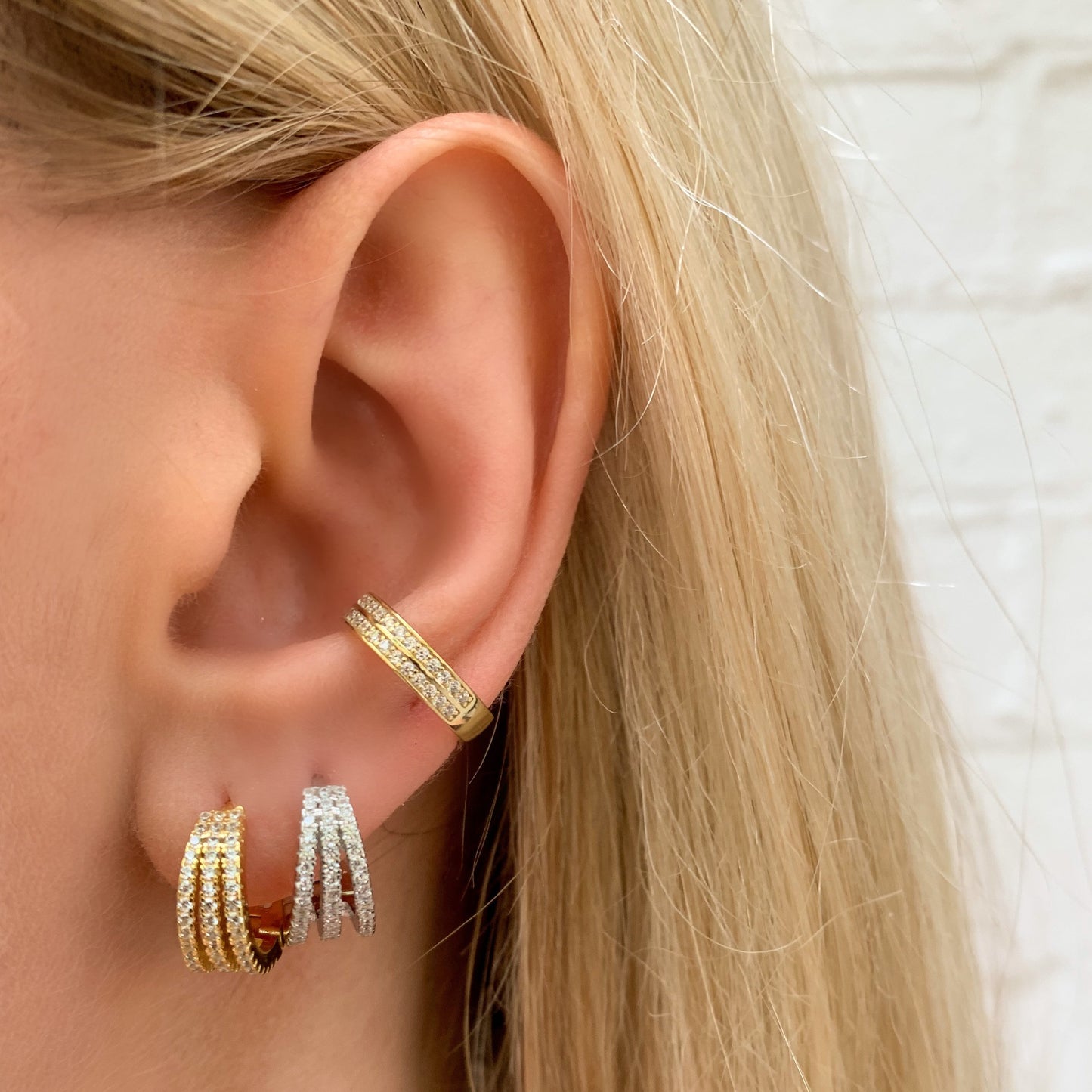 Simple three row cz small huggie hoop earrings on Alexandra