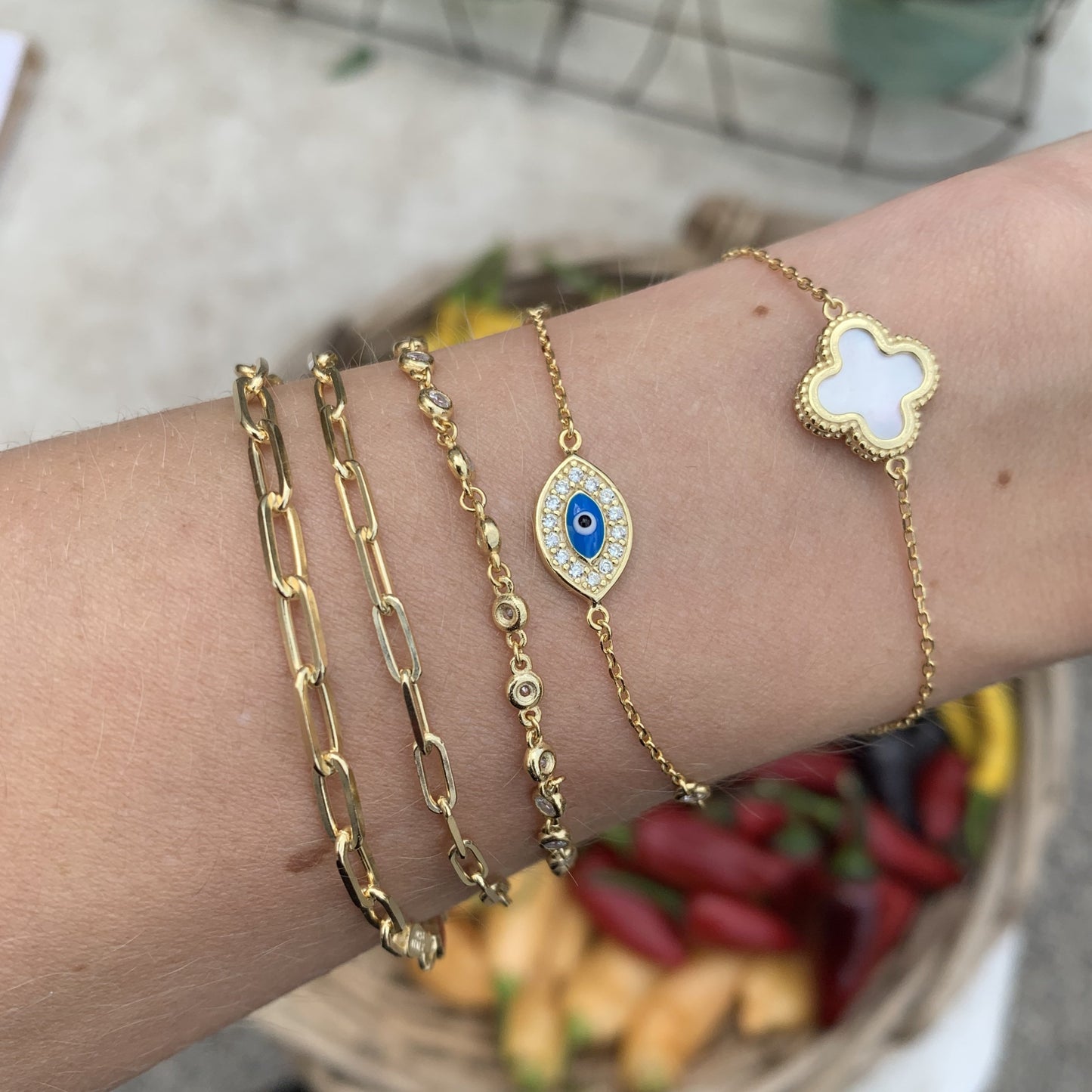 Layering our Alexandra Marks Blue Cz Evil Eye Bracelet in Gold