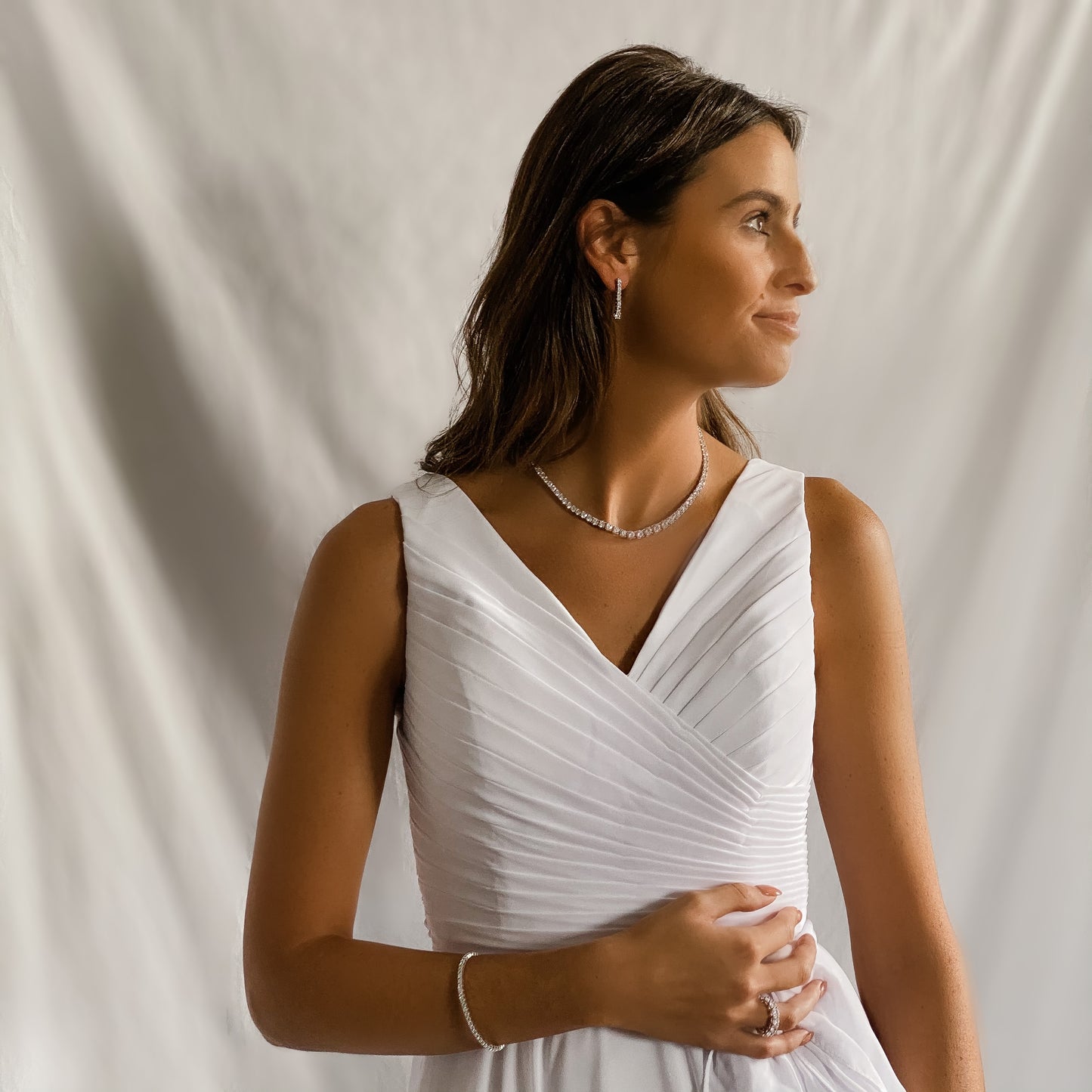 A bride wearing Alexandra's graduated CZ tennis necklace in sterling silver.