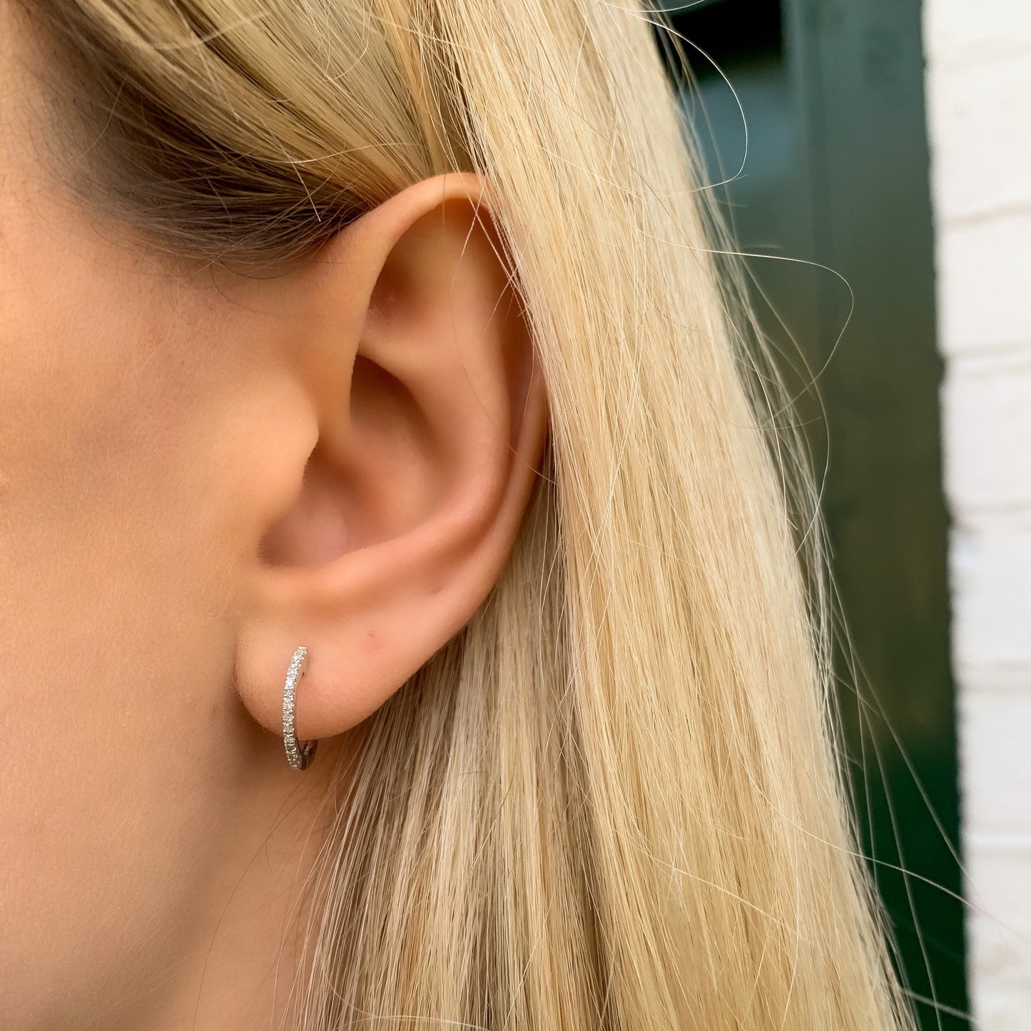 Wearing the petite pave' diamond huggie hoop earrings in 14kt white gold