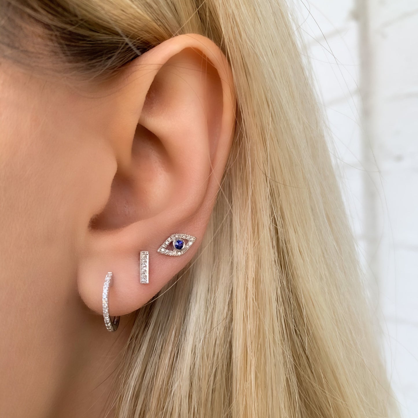 Wearing our 14kt White Gold & Diamond Huggie Hoop Earrings