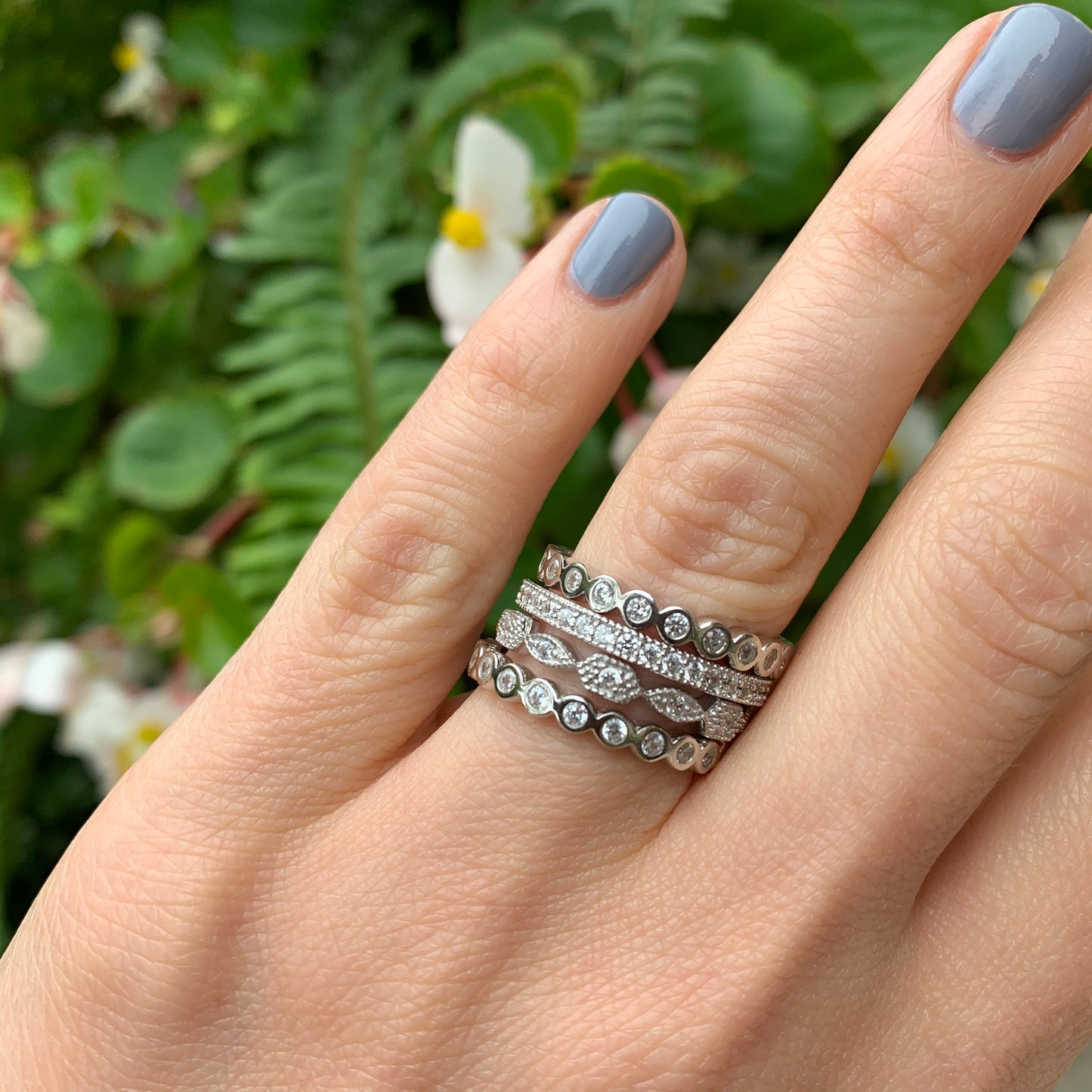 A stack of sterling silver & cz eternity band rings