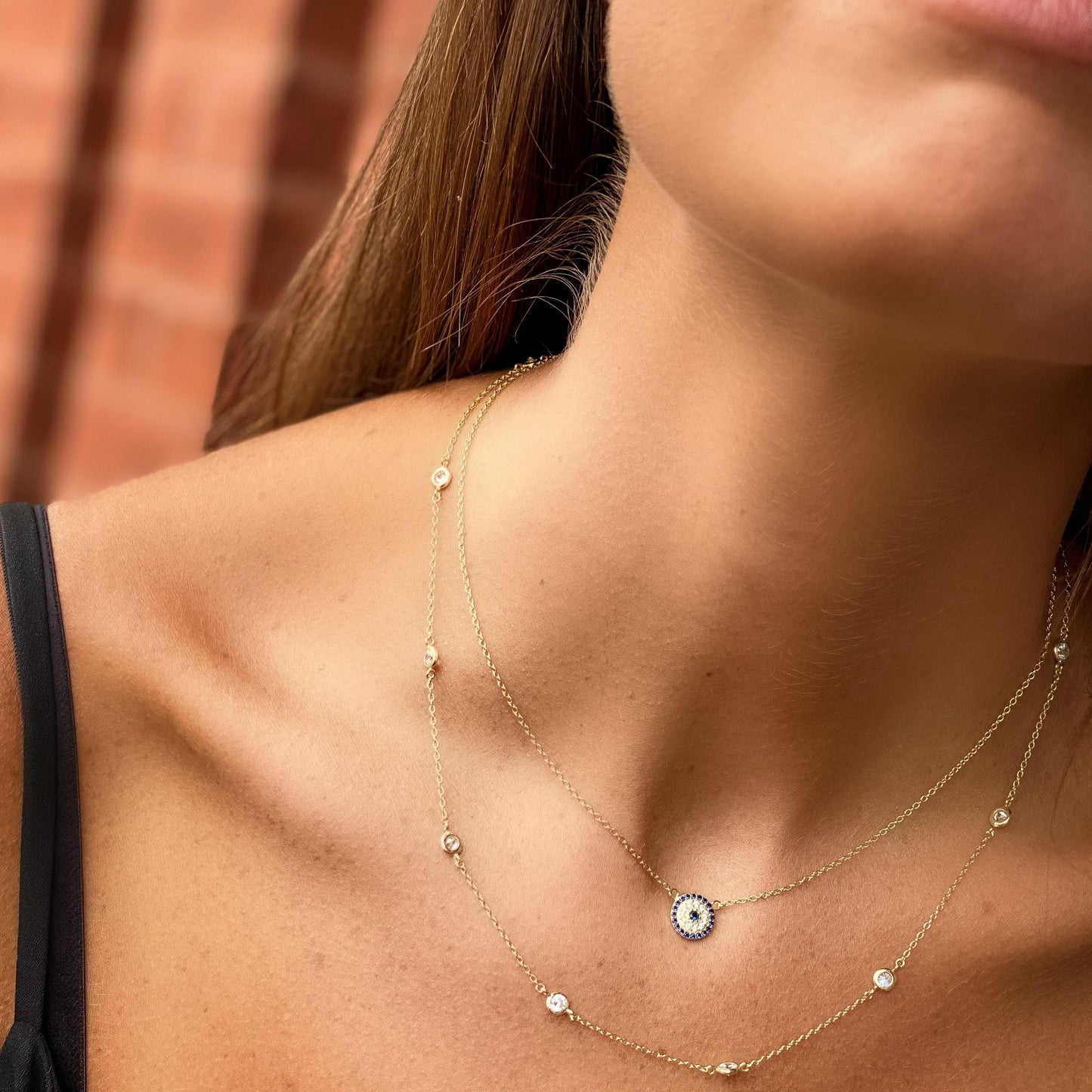 Wearing our small blue evil eye disc necklace at Alexandra Marks Jewelry