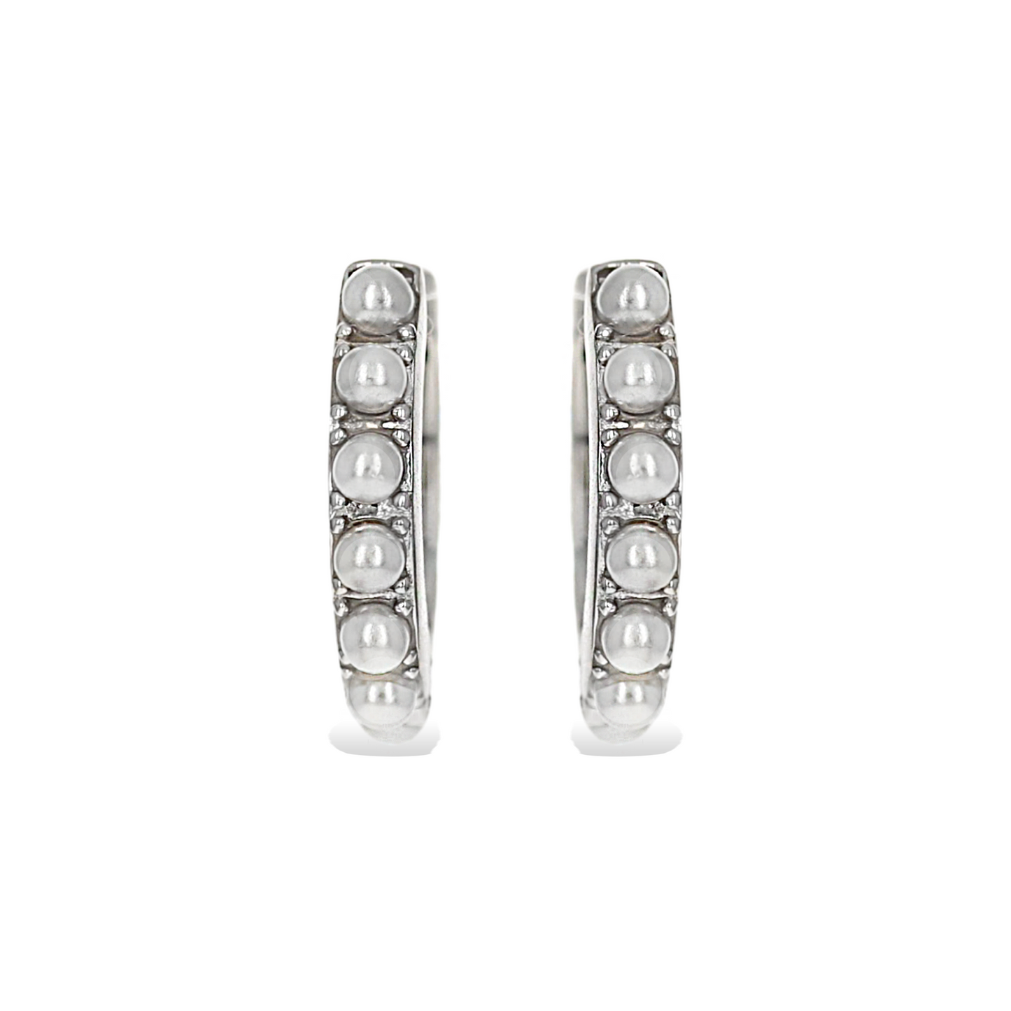 Front view of Alexandra Marks's white pearl huggie hoop earrings in silver
