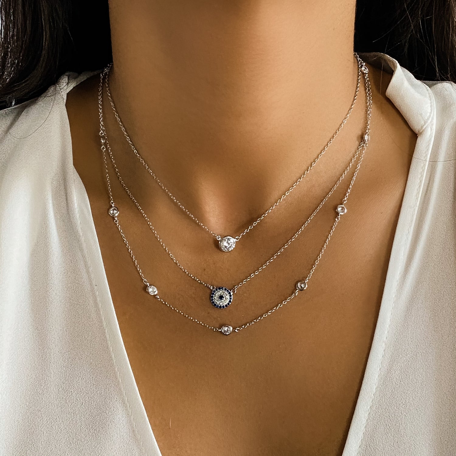 Layering three sterling silver and cz necklaces from Alexandra Marks Jewelry