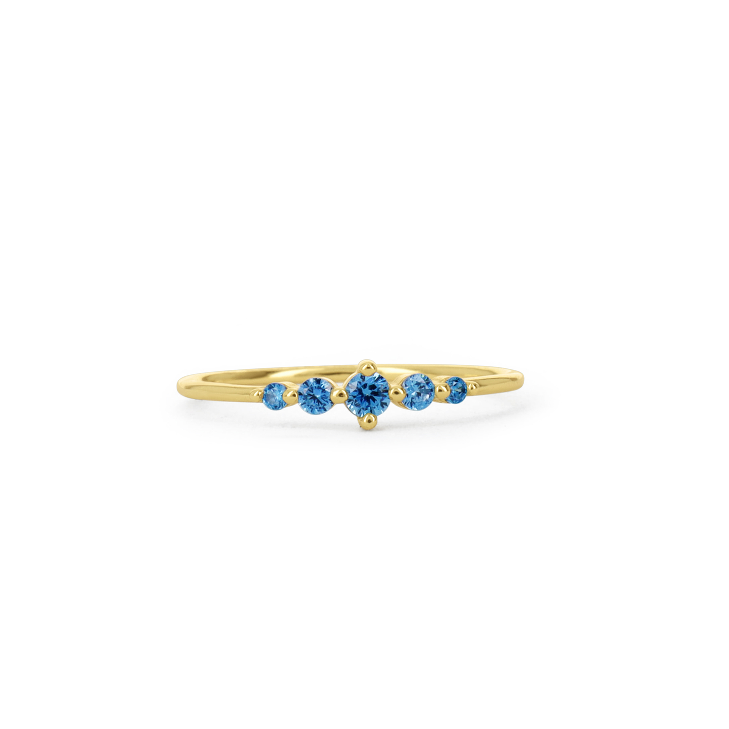 A delicate yellow gold ring featuring a row of five round-cut blue gemstones, set against a plain white background.