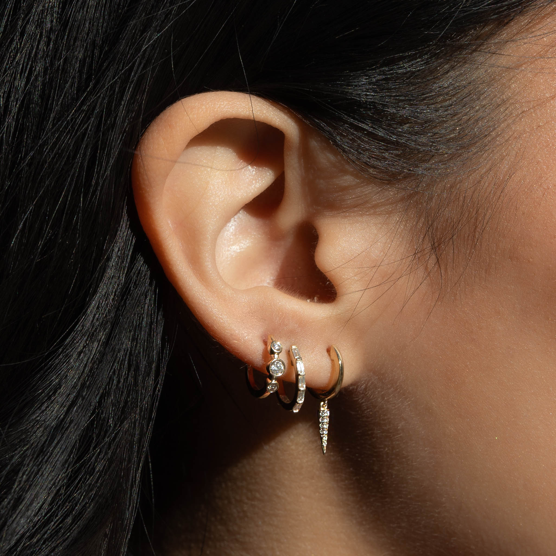 Dainty diamond huggie hoop earrings from Alexandra Marks Jewelry