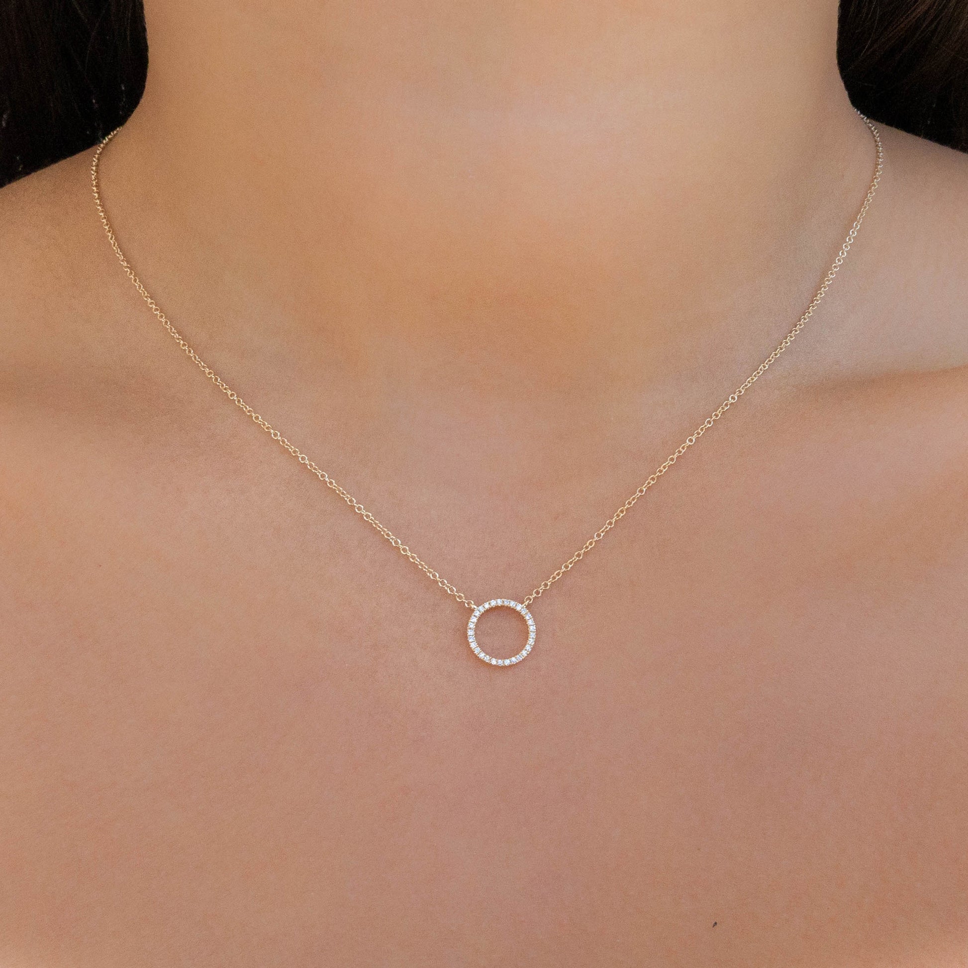 Gold open circle necklace with pave' diamond stones in gold. 