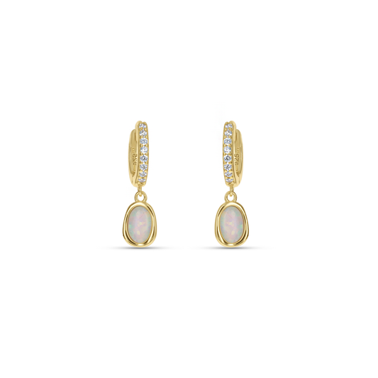 Dainty White Opal Gold Huggie Hoop Earrings from Alexandra Marks Jewelry. 
