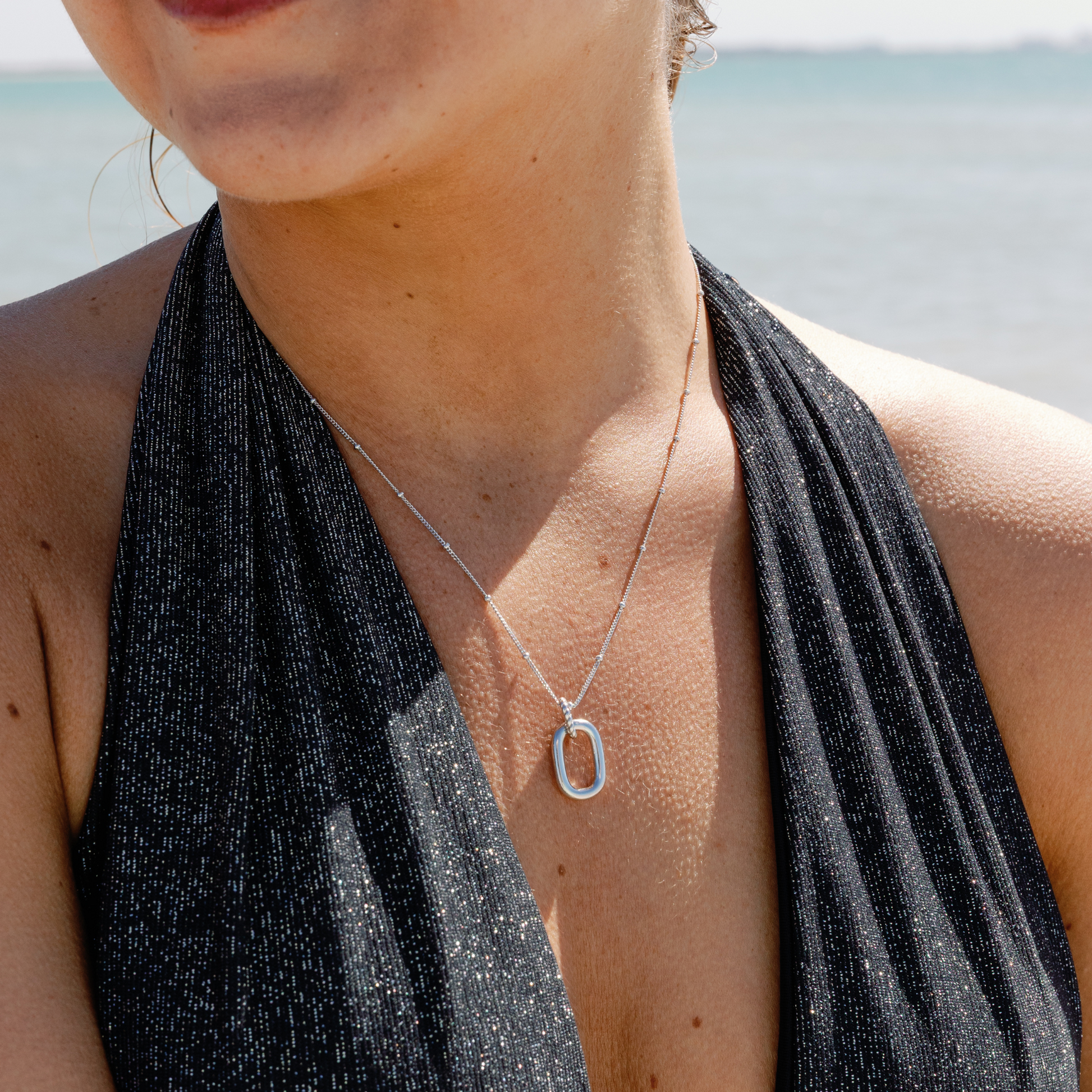 Sterling Silver Modern Open Oval Pendant Necklace on a person
