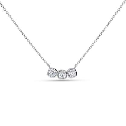 A delicate silver chain necklace featuring a horizontal bar with three small, bezel-set round clear CZ stones from Alexandra Marks Jewelry. 