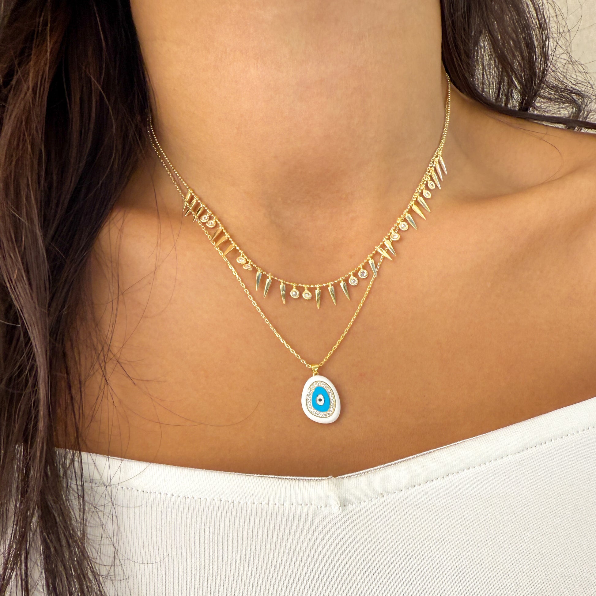Gold Necklace with a white evil eye pendant 