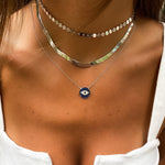 model layering our pave' cz evil eye disc necklace in sterling silver