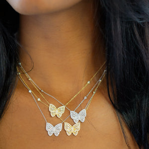 
            
                Load image into Gallery viewer, Wearing the gold and silver cz Butterfly Necklaces from Alexandra Marks Jewelry
            
        