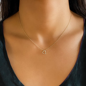 Wearing the sideways small diamond heart necklace from Alexandra Marks Jewelry