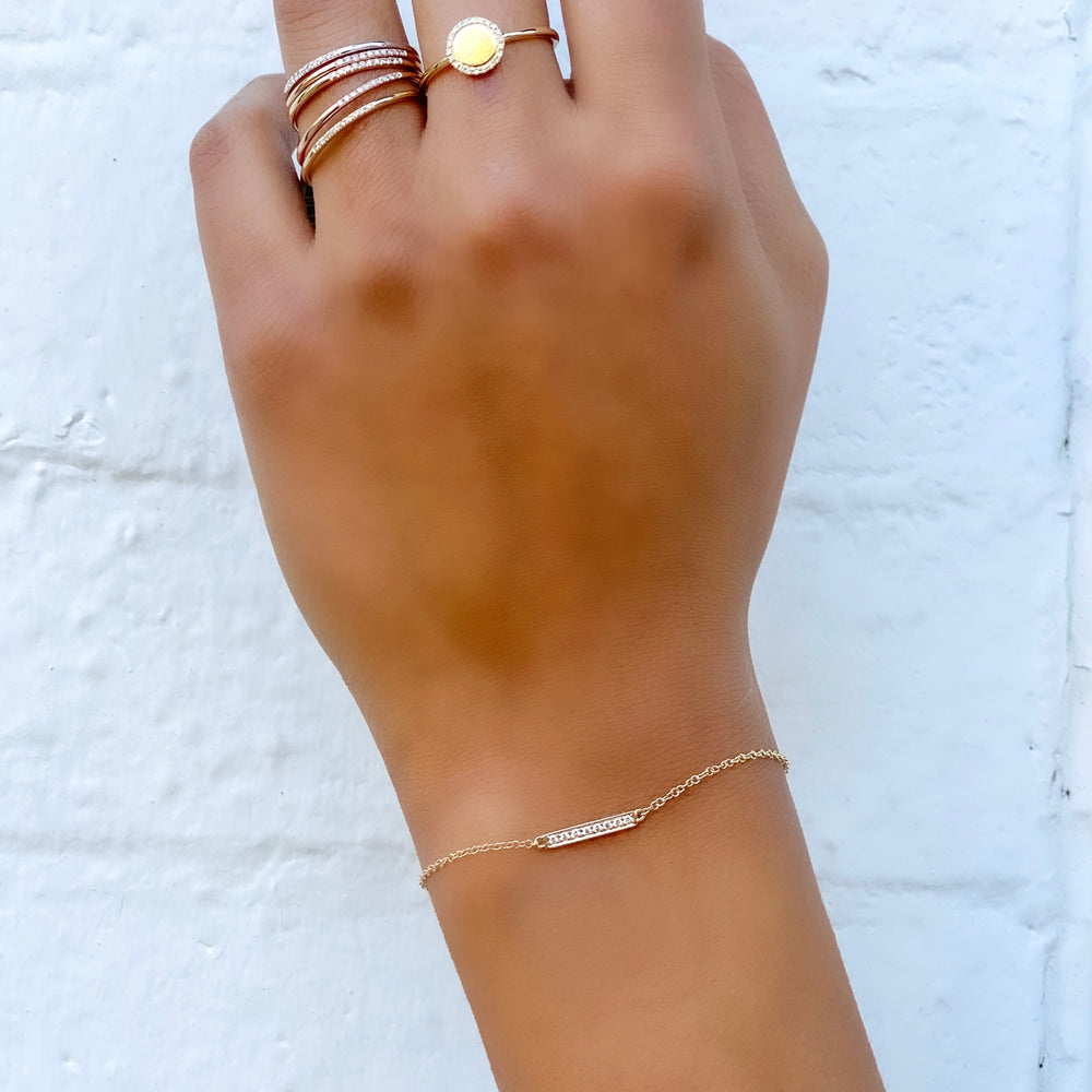 Wearing the 14kt yellow gold dainty diamond bar bracelet