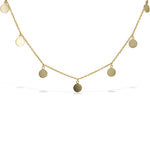 High polished plain discs hang from a thin chain necklace in gold