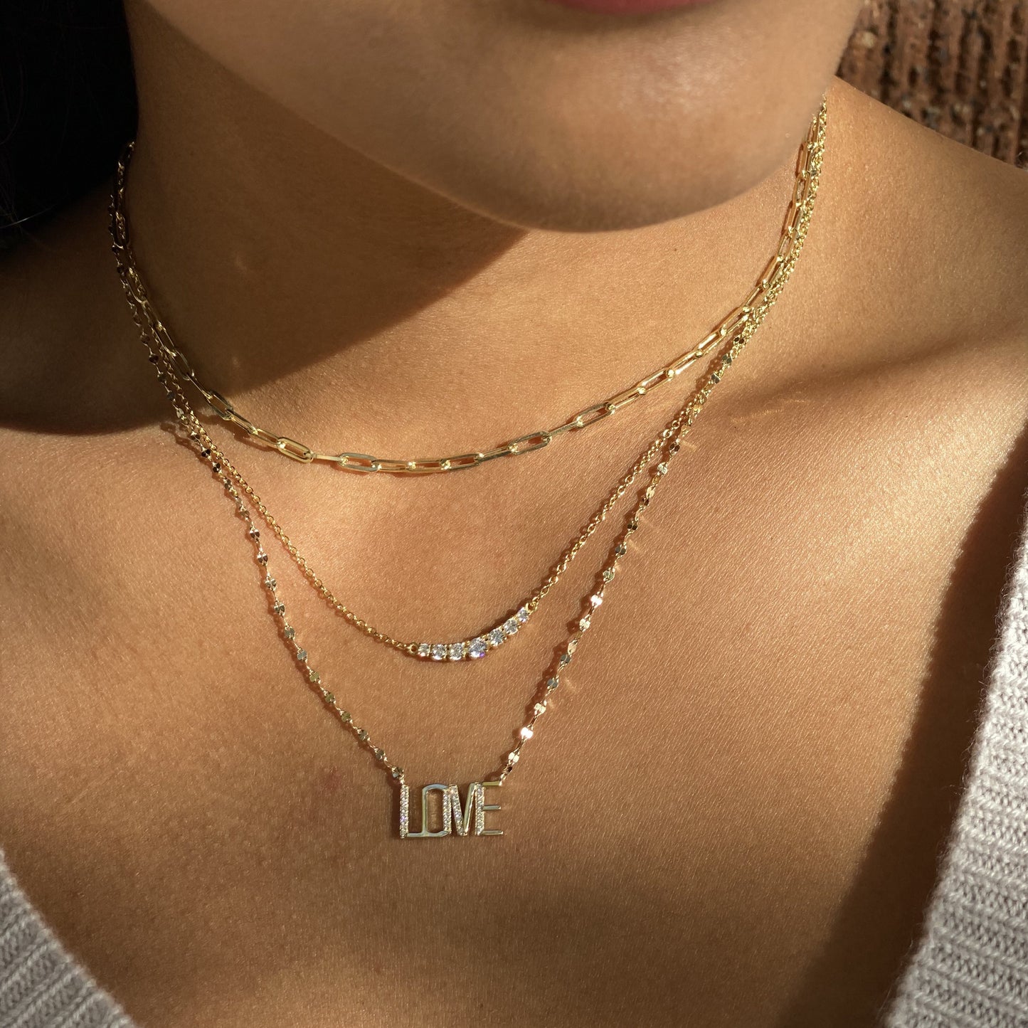 Alexandra Marks | Layering our gold LOVE letter diamond cut necklace