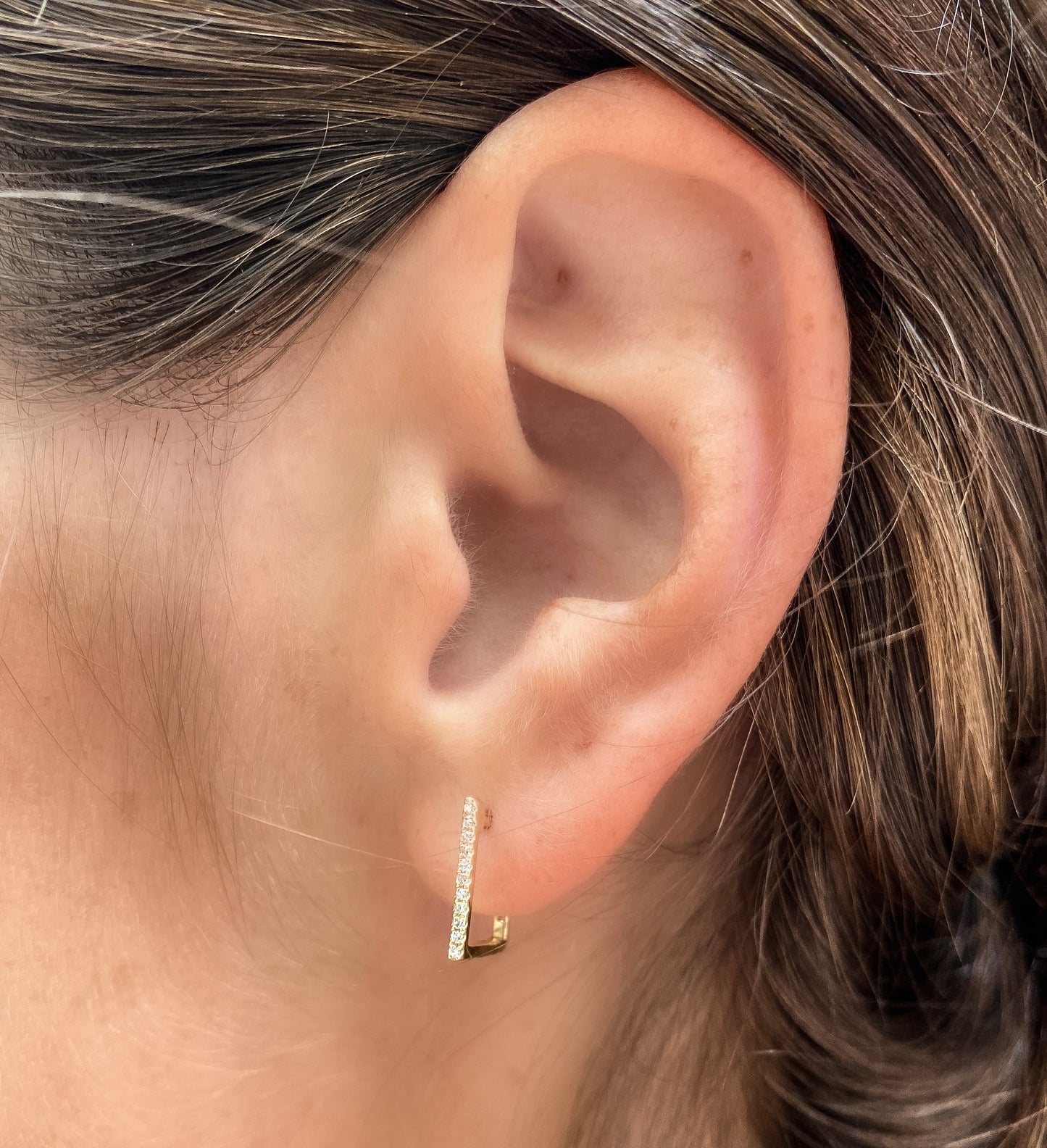 Wearing the square shaped huggie hoop earrings from Alexandra Marks Jewelry