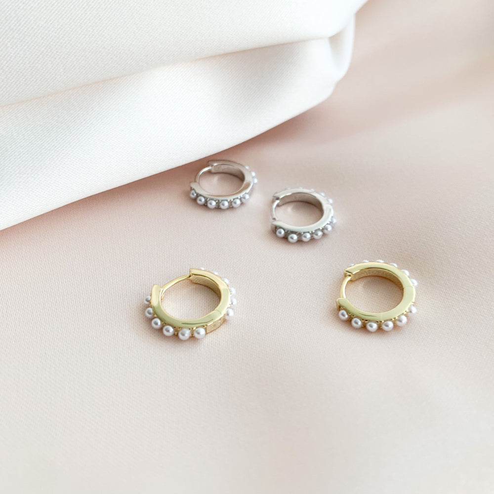 The gold and silver pearl huggie hoops earrings from Alexandra Marks Jewelry
