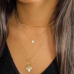 
            
                Load image into Gallery viewer, Layering our 3ctw bezel set cz necklace with two other gold AMJ necklaces
            
        