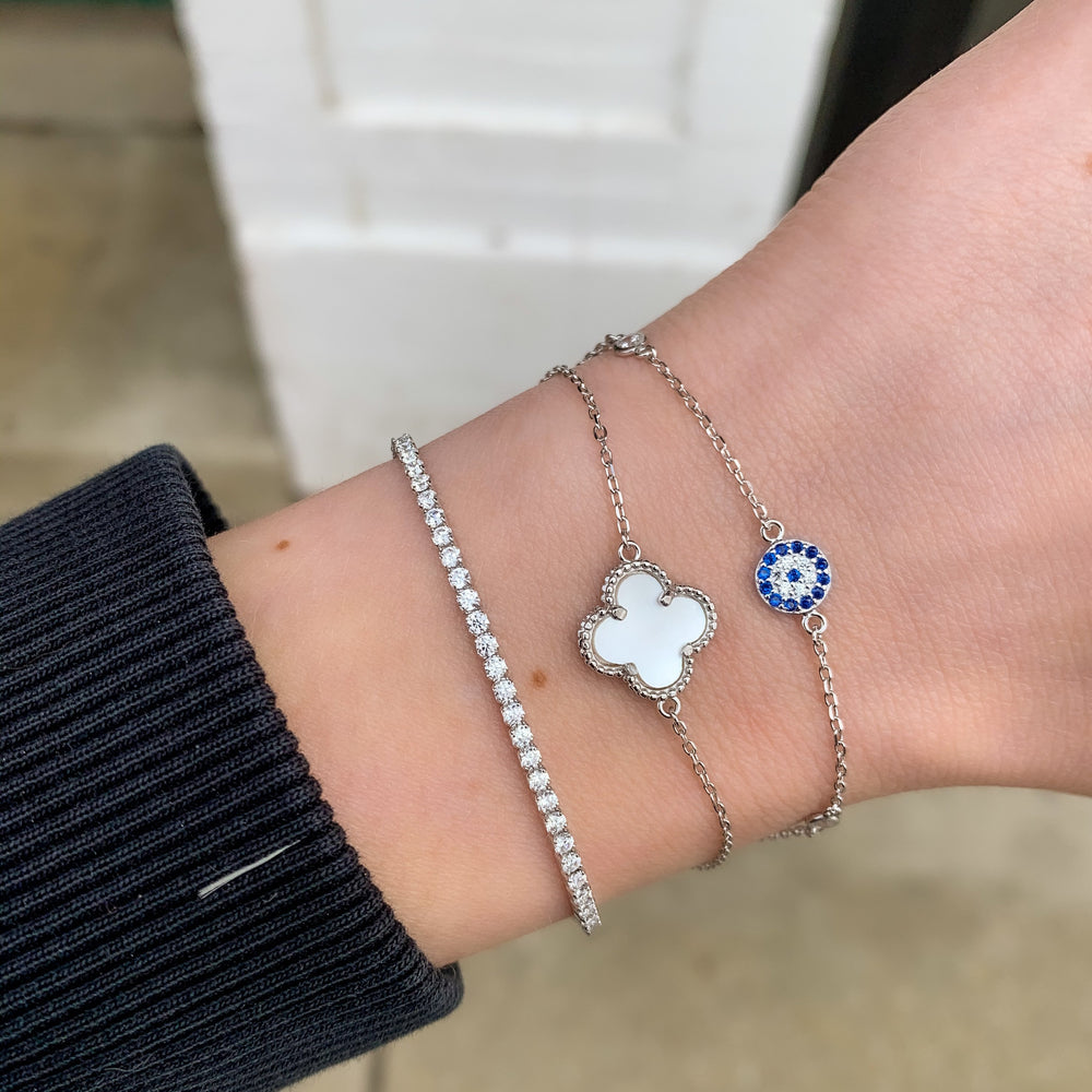 
            
                Load image into Gallery viewer, Stacking our dainty evil eye disc bracelet with our pearl clover and thin cz drawstring bracelet in sterling silver - ALexandra Marks Jewelry
            
        