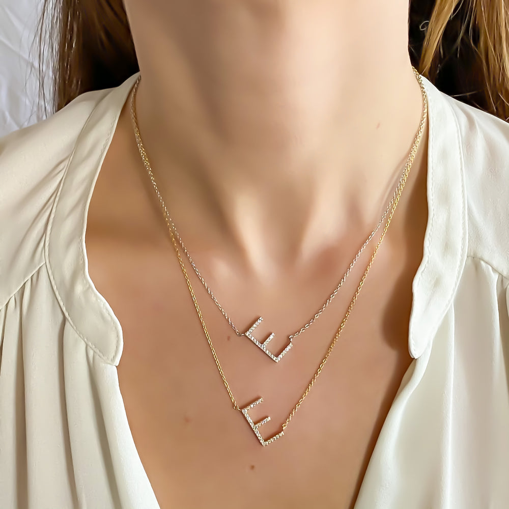 Wearing the gold and silver Sideways Cz Letter E Initial Necklaces