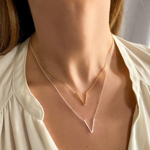 
            
                Load image into Gallery viewer, Wearing the silver and gold letter v necklaces from Alexandra Marks Jewelry
            
        