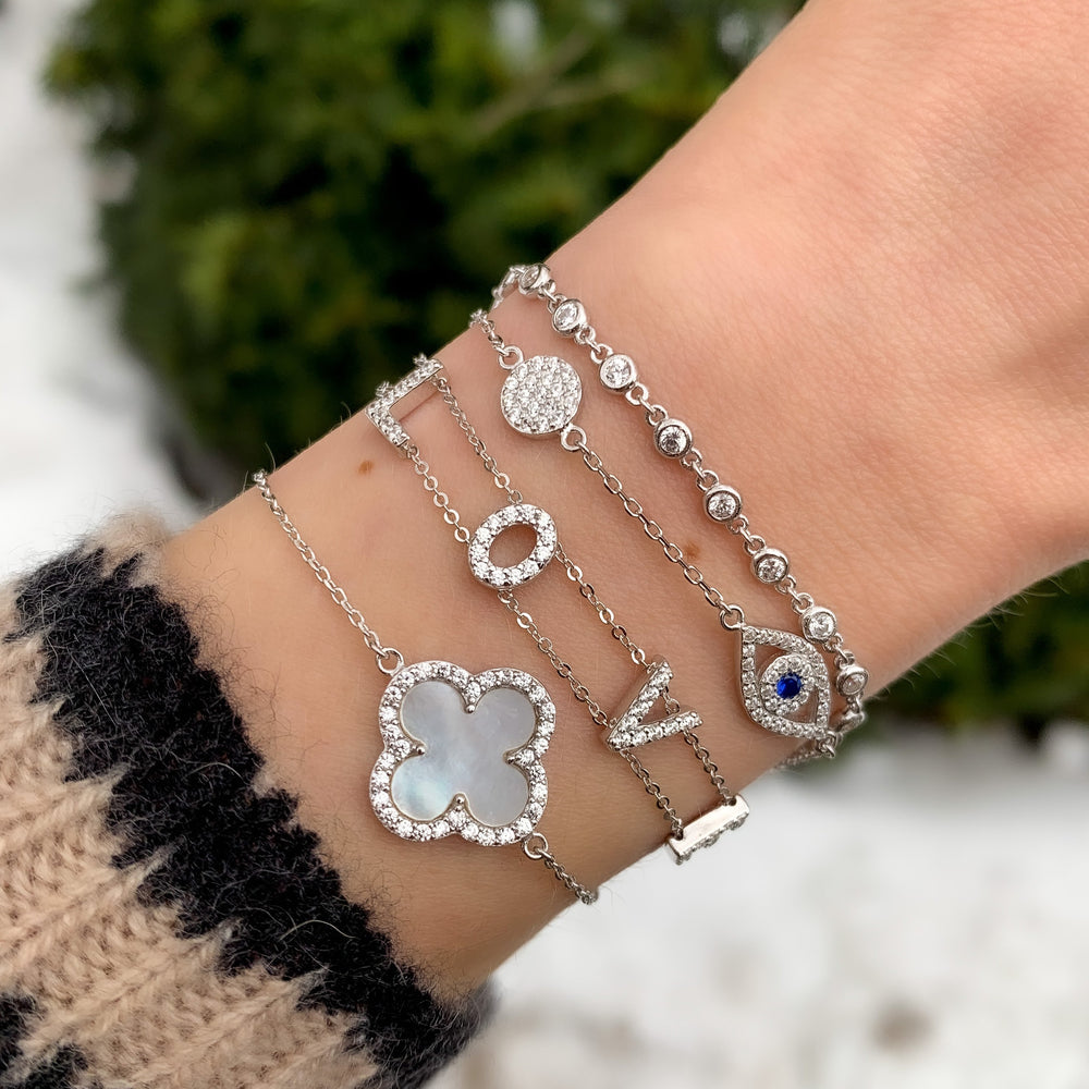 Stacking the silver evil eye bracelet from Alexandra Marks Jewelry