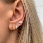 Alexandra Marks wearing the extra small gold cz hoop earrings in her second earring hole