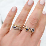 Wearing two different evil eye ring styles in gold and silver