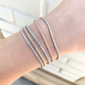 Wearing multiple cubic zirconia tennis bracelets from Alexandra Marks Jewelry