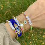 Stacking our gold evil eye bracelet at Alexandra marks Jewelry