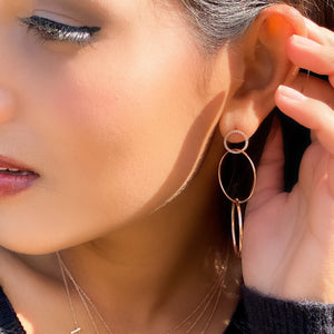 making a statement in our open circle 14kt rose gold and diamond drop earrings