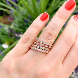 Stacking multiple rose gold & CZ enternity bands from Alexandra Marks Jewelry