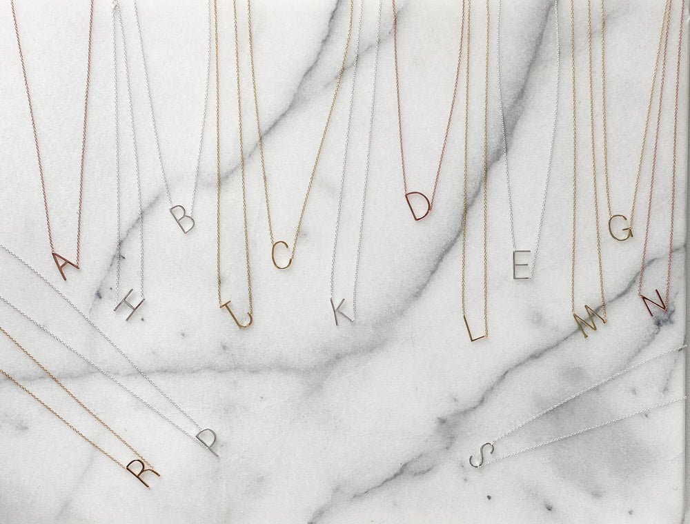 Best selling sideways initial necklaces in gold, silver and rose gold from Alexandra Marks Jewelry