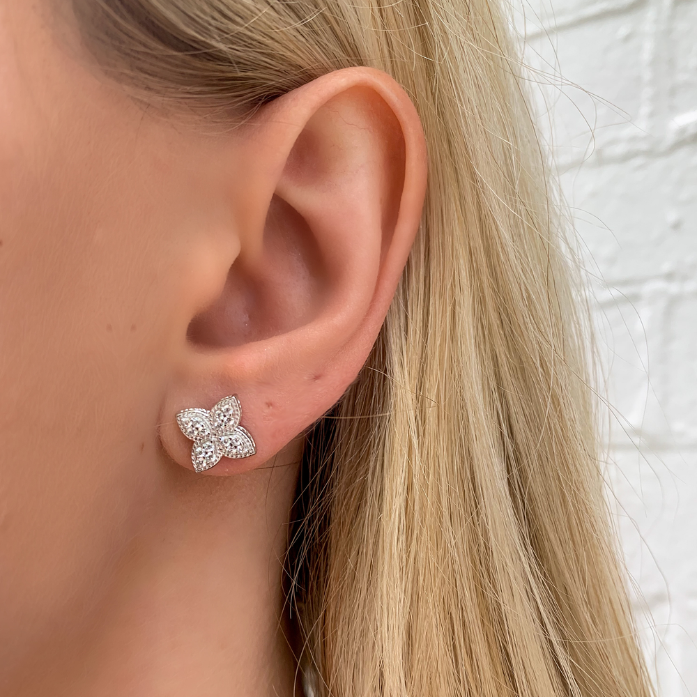 
            
                Load image into Gallery viewer, Wearing the silver pointed flower stud earrings from Alexandra Marks Jewelry
            
        