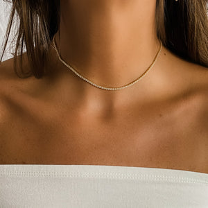 
            
                Load image into Gallery viewer, Wearing the thin gold tennis necklace from Alexandra Marks Jewelry
            
        
