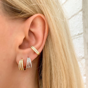 
            
                Load image into Gallery viewer, Alexandra wearing the triple row cz huggie hoop earrings in gold and silver
            
        