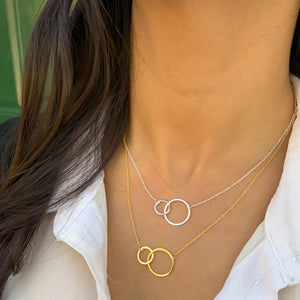 Wearing the silver and gold interlocking double circle necklace from Alexandra Marks Jewelry