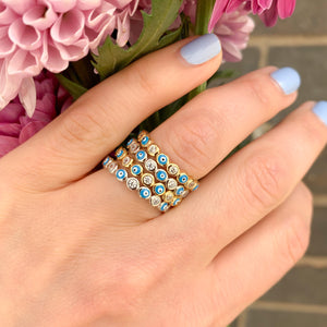 Stacking the silver and gold evil eye turquoise enamel eternity band rings in silver and gold from Alexandra Marks Jewelry